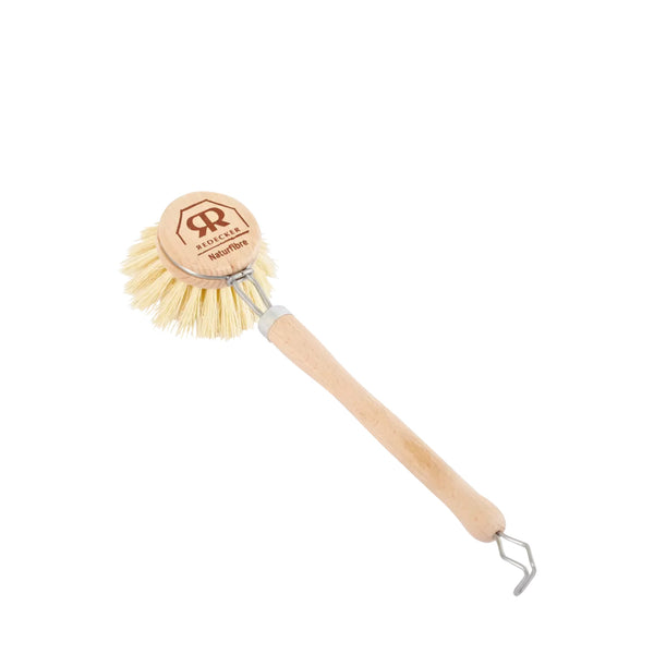 Dishwashing brush with wooden handle and circular bristle head on a white background