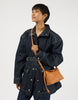 Model wearing the compact Wild Oak leather crossbody bag