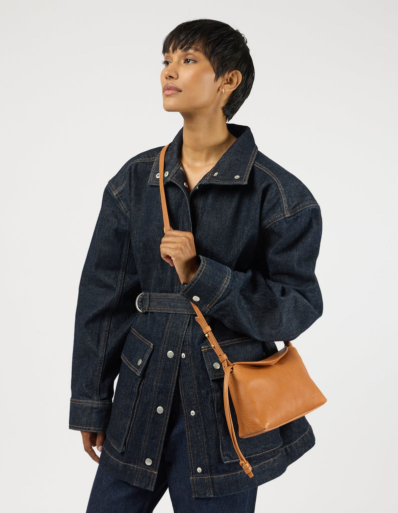 Model wearing the compact Wild Oak leather crossbody bag