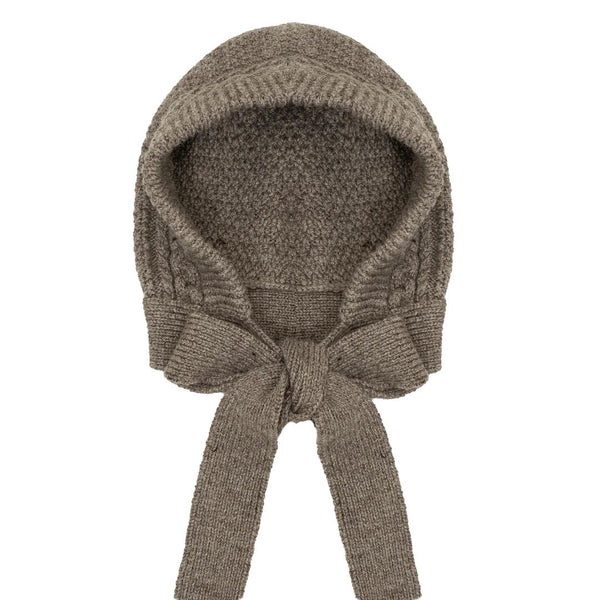 Knitted bonnet with a bow on a white background