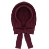 Knitted burgundy baby bonnet with a bow on a white background