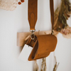 vegetable-tanned-leather-wide-strap-crossbody-purse-hanging-view-closeup